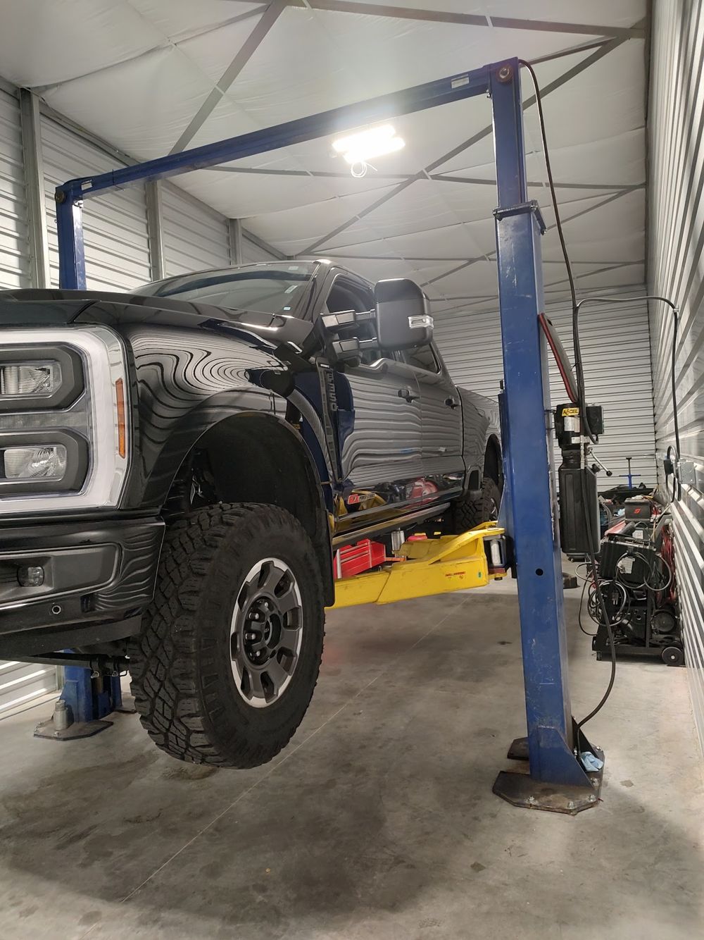 Pickup truck up on the lift in Kelly’s Boise shop